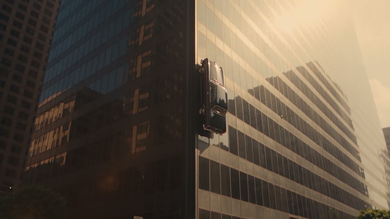 A coupe driving up a skyscraper